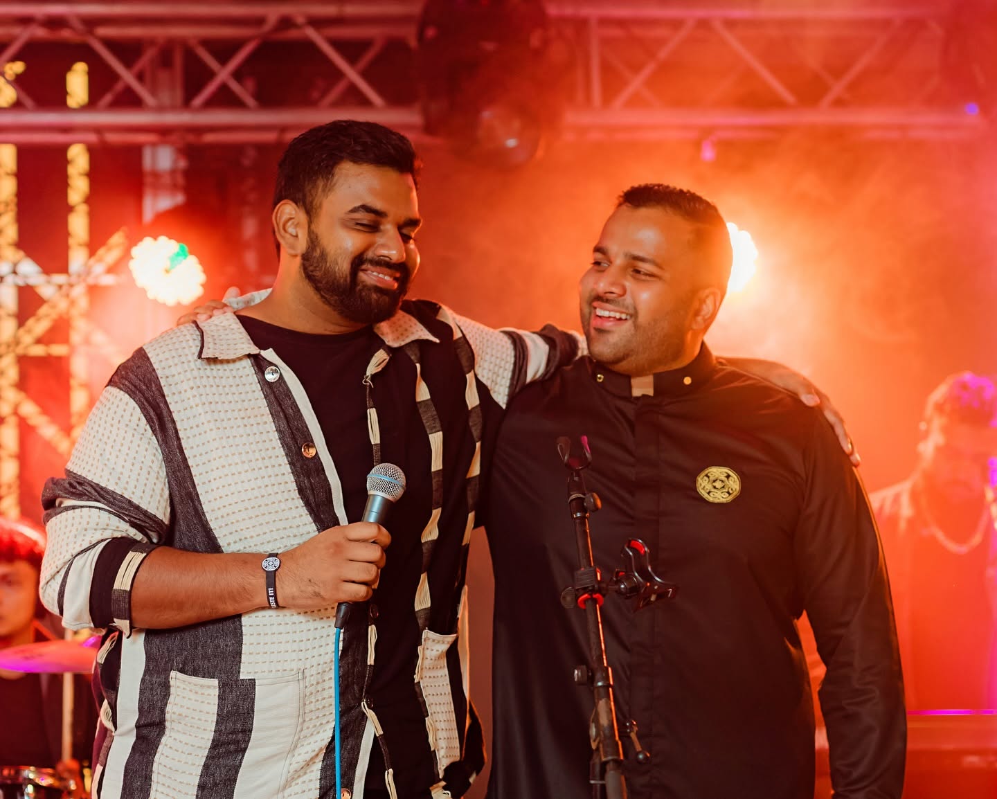 Two people sharing a celebration moment on stage