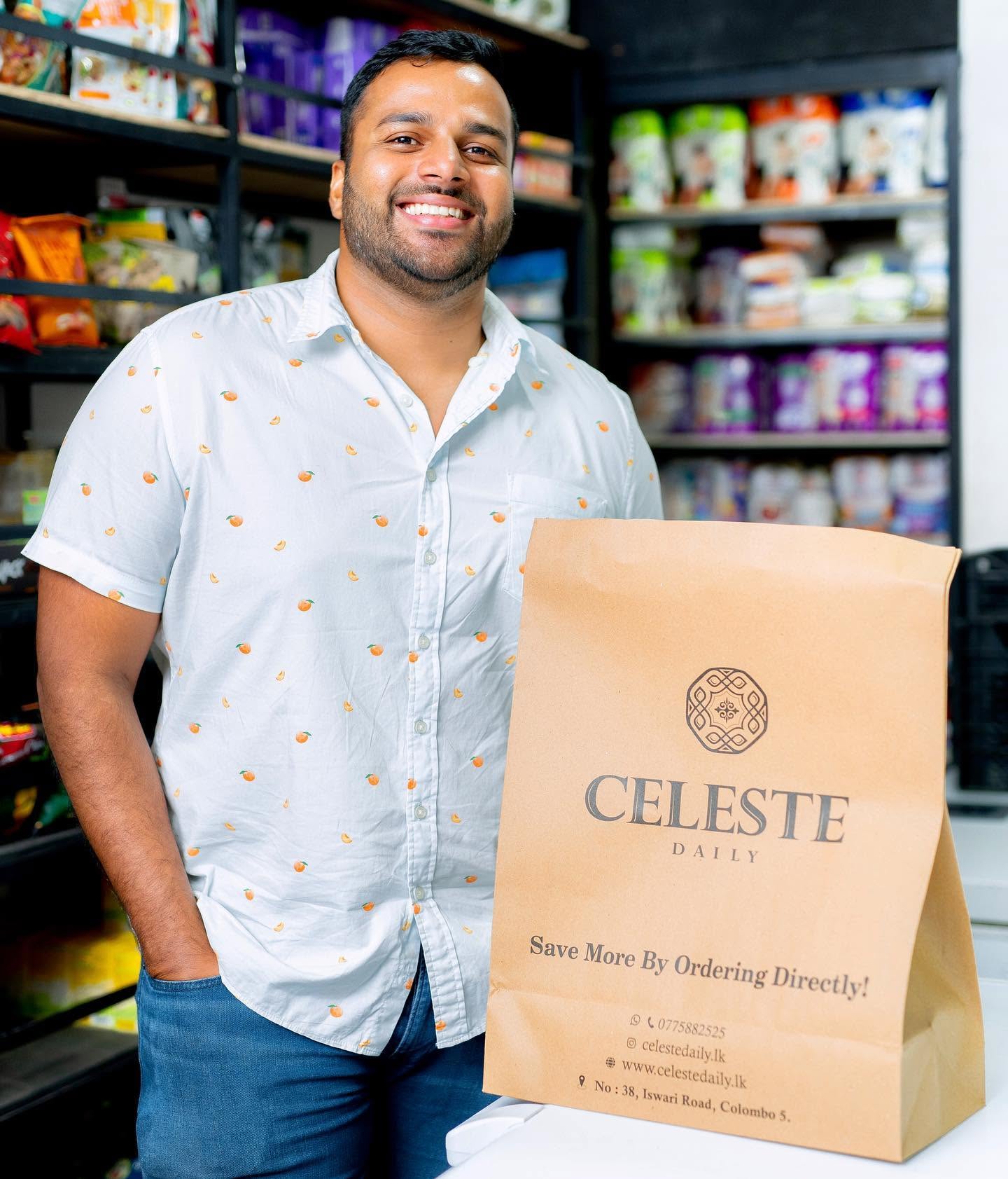 Person holding a Celeste shopping bag inside a retail store