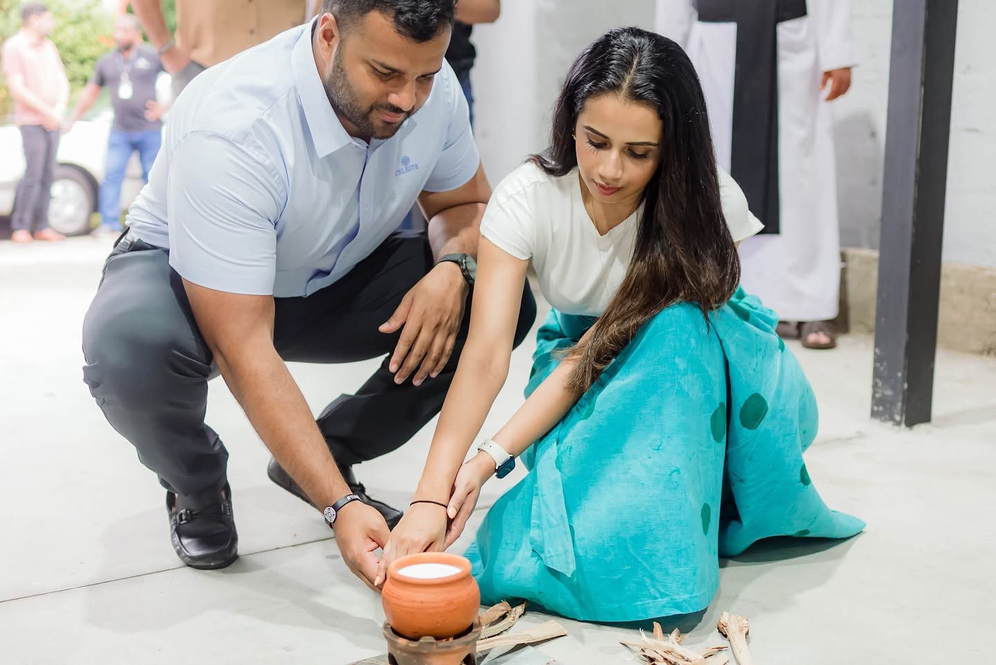 Two people taking part in a ceremonial tree-planting activity